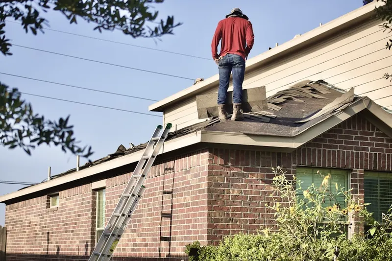 Professional roofer working on a residential roof in Saint Mary